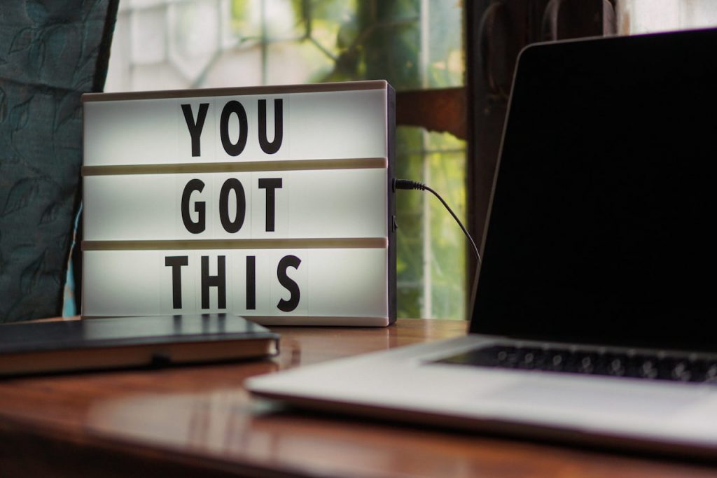 Light up sign on a desk which says "You Got This"